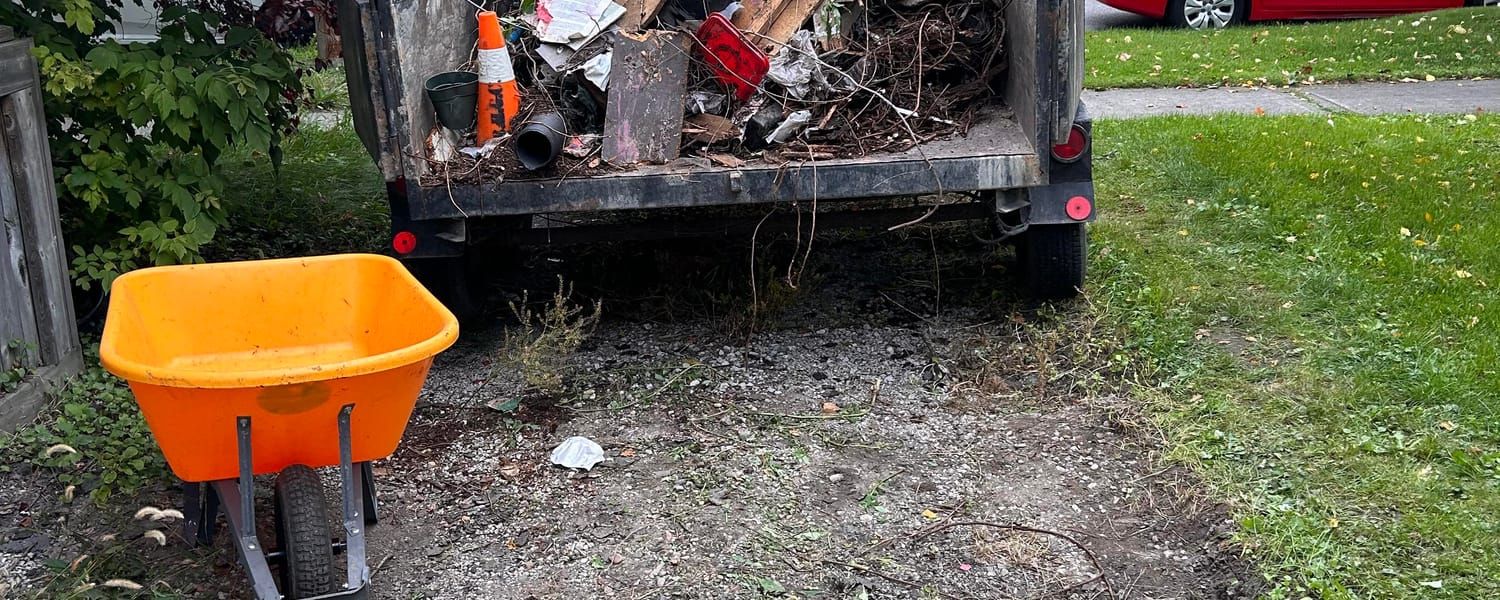 Trailer loaded with yard debris and junk during a property cleanout