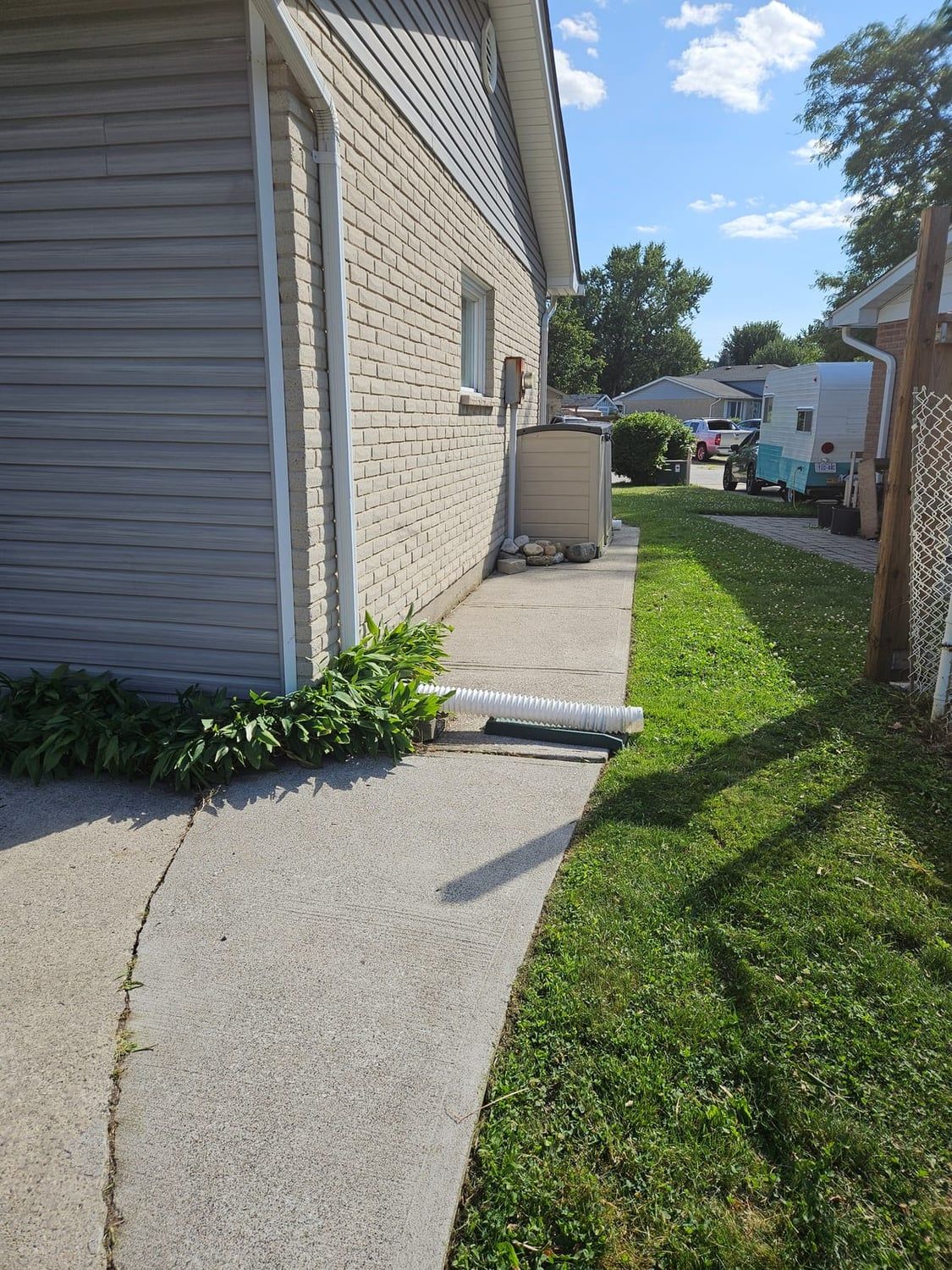 A walkway and foundation cleared and tidied after a cleanup