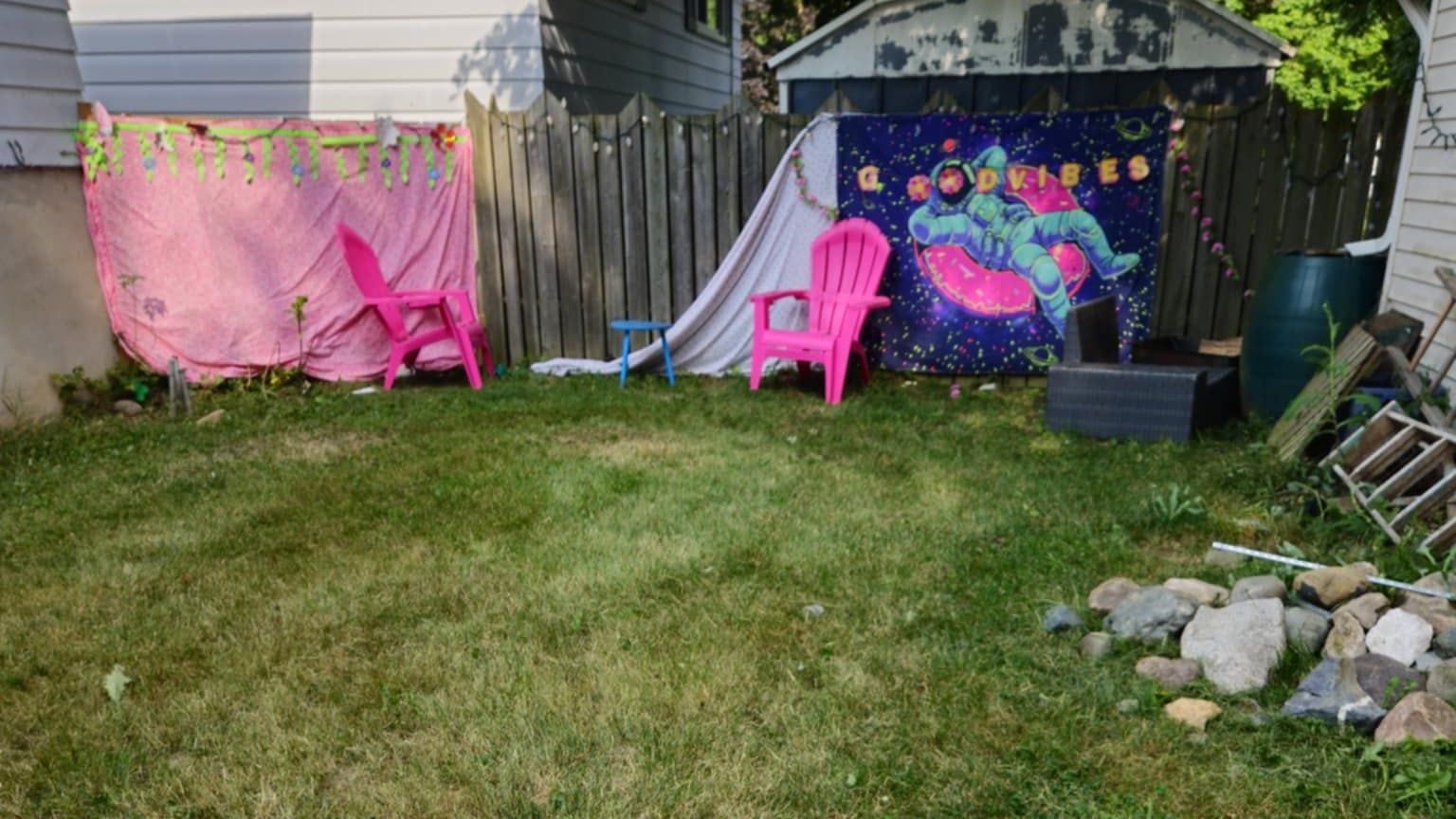 The same backyard after mowing, cut short and tidied up to the fence