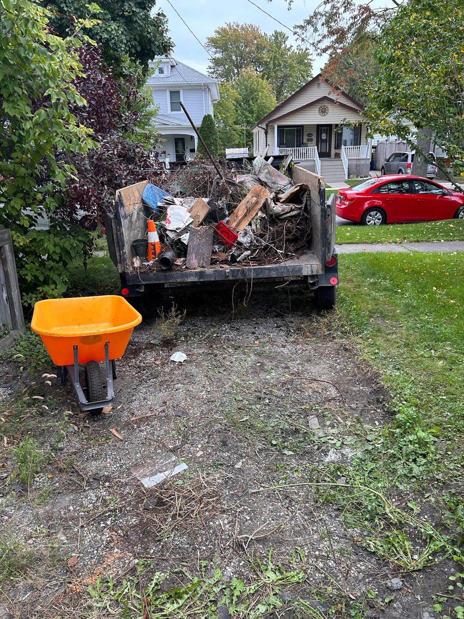 Trailer loaded with yard debris and junk during a property cleanout